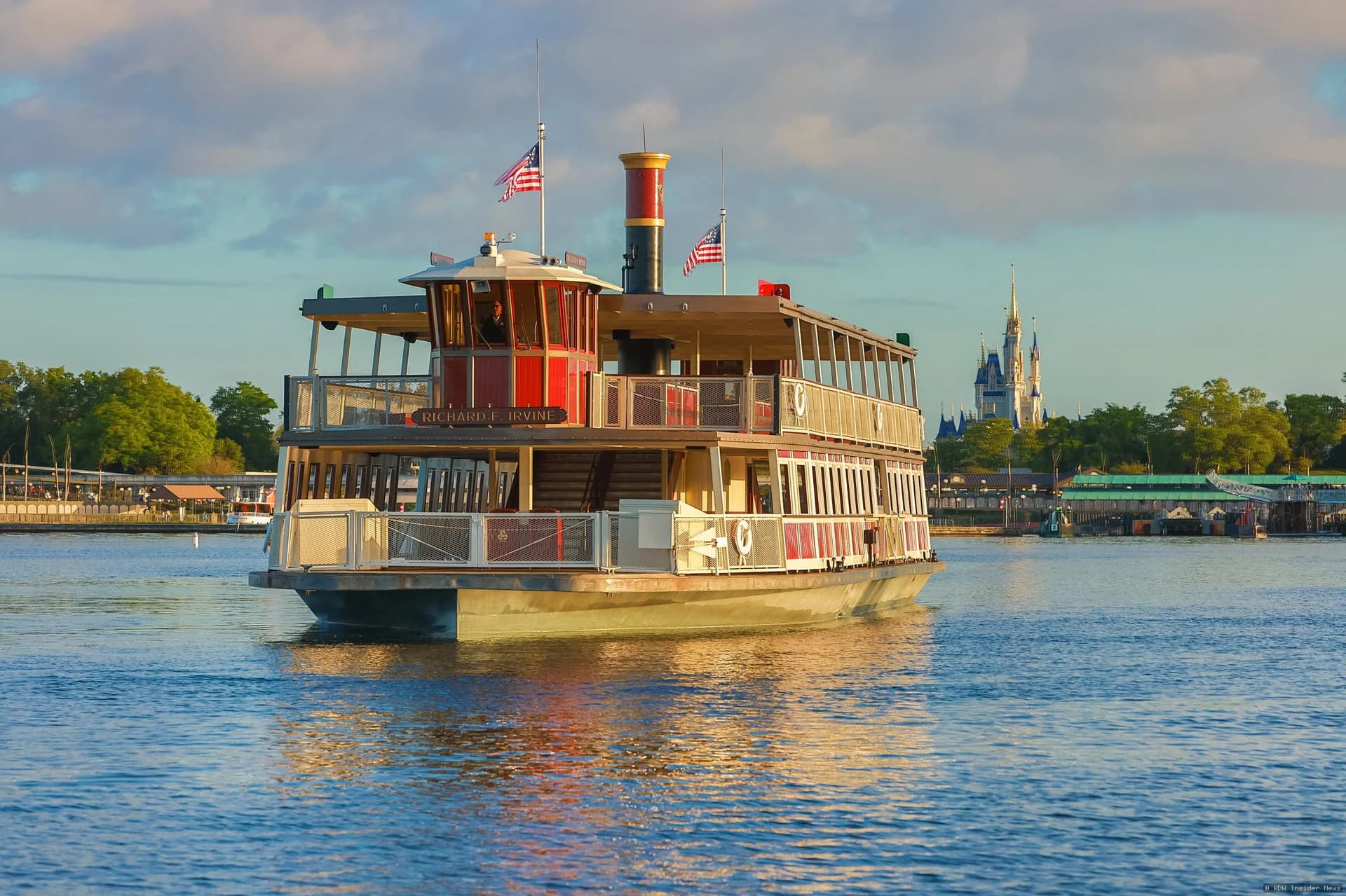 A white ferryboat docked at Magic Kingdom's ferry terminal with Victorian-style architecture and Walt Disney World…