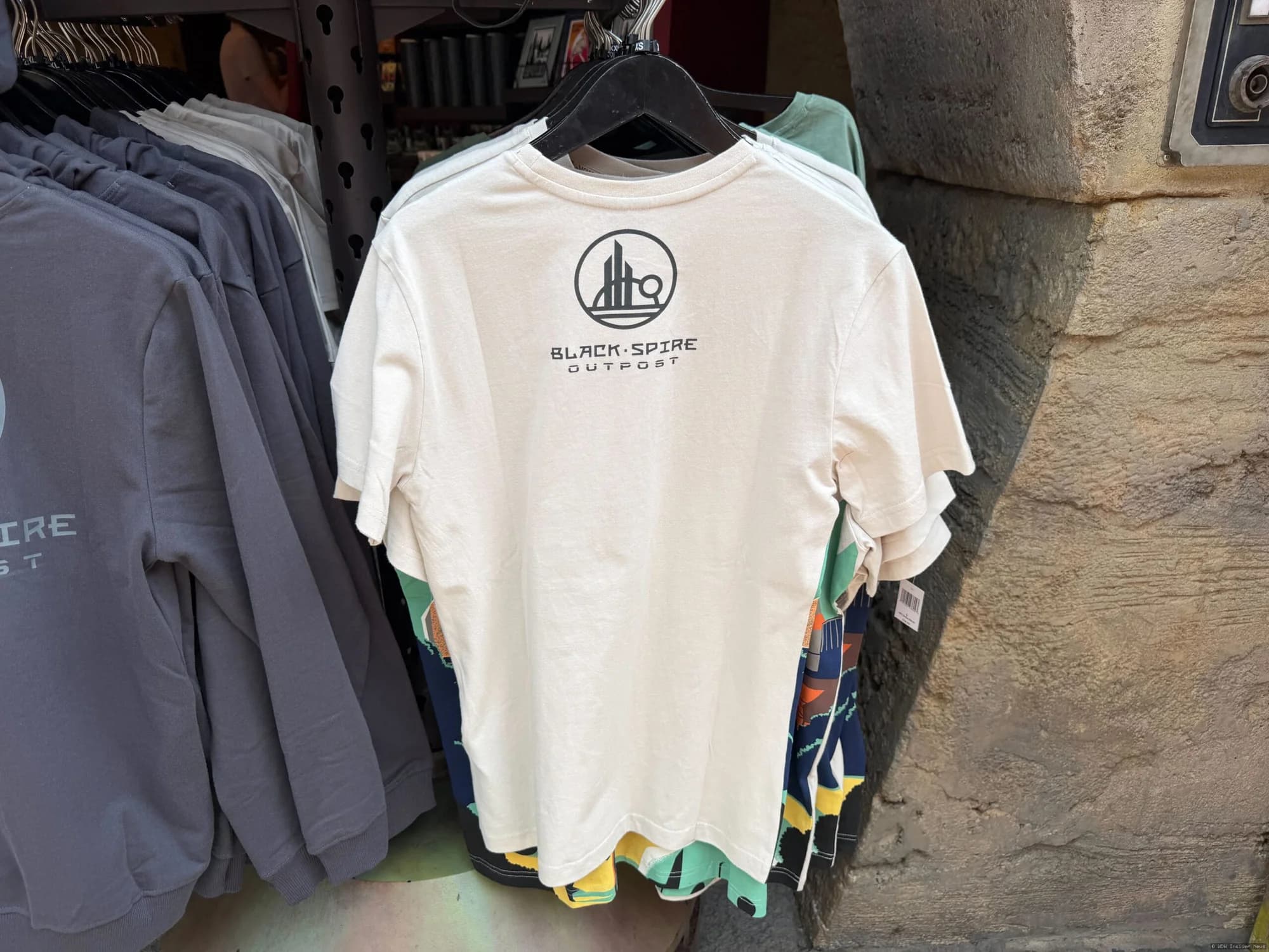 Star Wars merchandise display featuring apparel, collectibles and drinkware at Disney World's Galaxy's Edge themed area