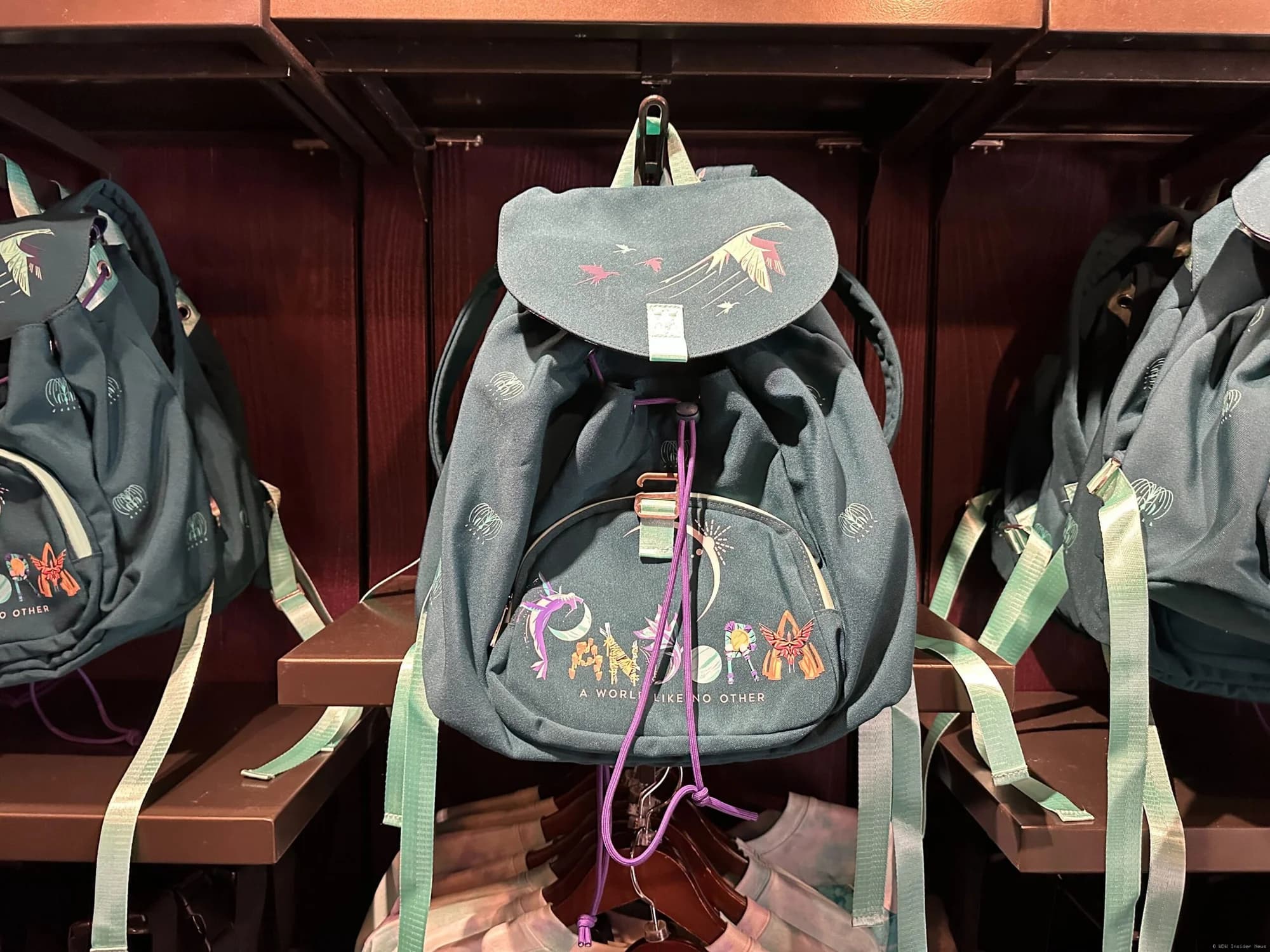 Blue drawstring backpack with Pandora branding displayed in Disney's Animal Kingdom merchandise shop
