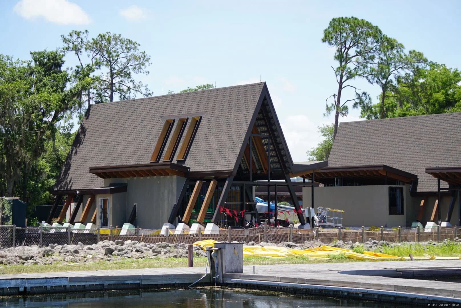 Partially constructed A-frame cabins with completed roofing at Disney Lakeshore Lodge construction site