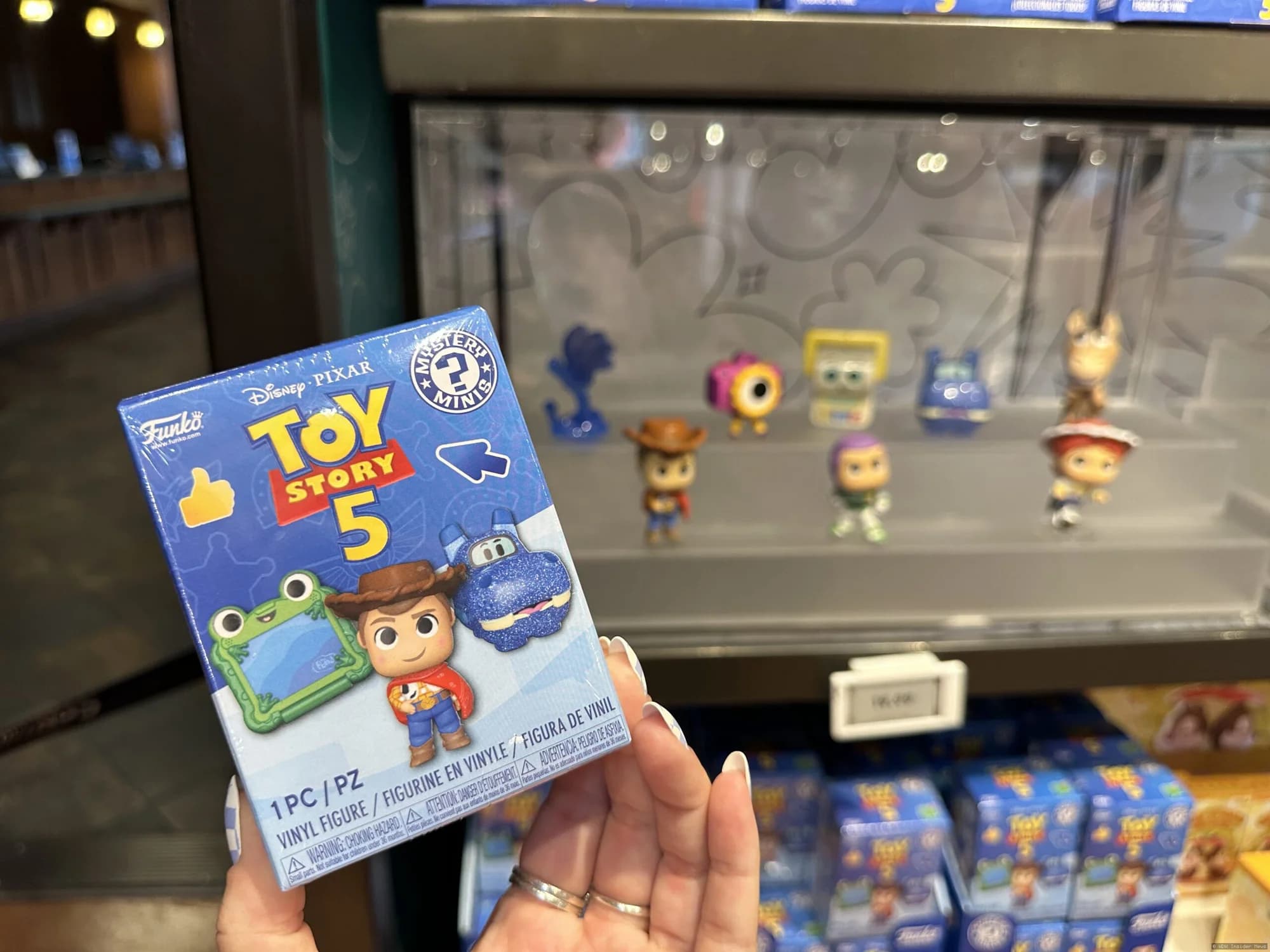 Mystery boxes displayed at Disney Springs featuring Stitch, Toy Story 5 and sweet treat themed collectible merchandise