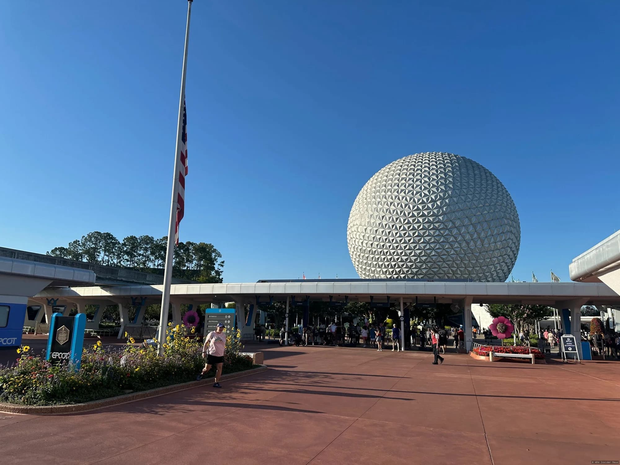 Flags at half-mast at a Walt Disney World theme park during daytime, honouring Peace Officers Memorial Day