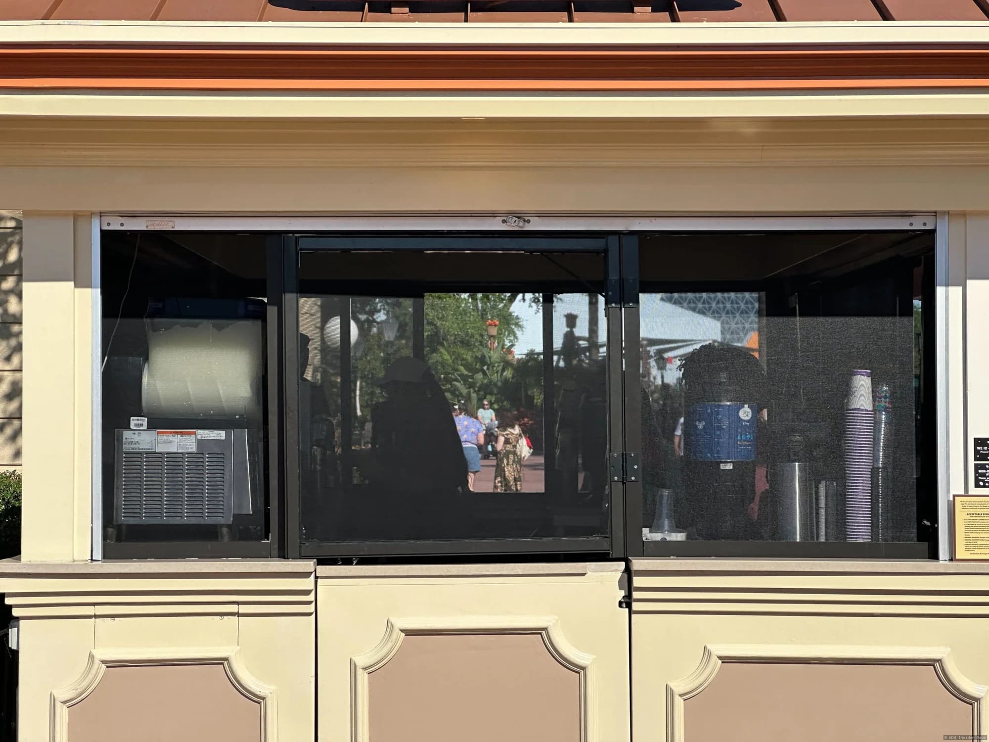 Protective mesh screens installed on the exterior of a Joffrey's coffee kiosk in EPCOT to prevent insects from entering