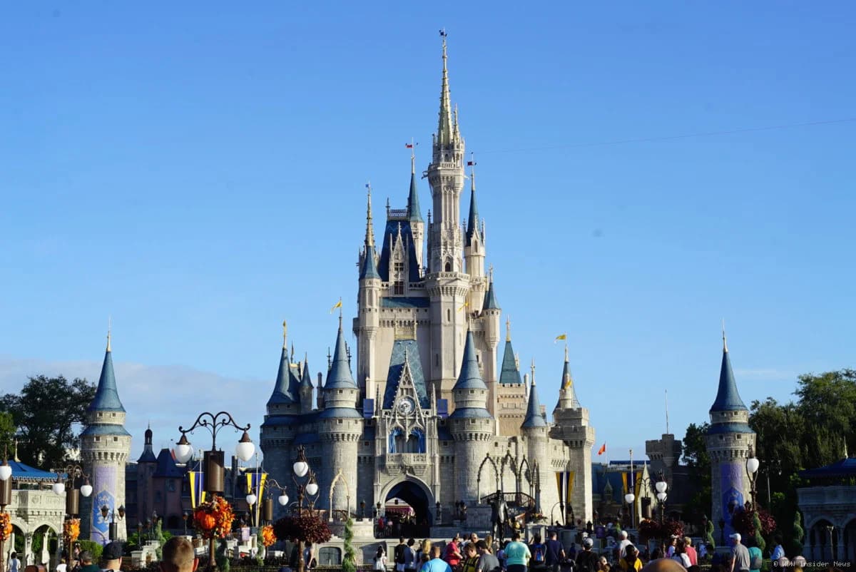 Cinderella Castle at Magic Kingdom with construction cranes being removed from around its base during repainting work