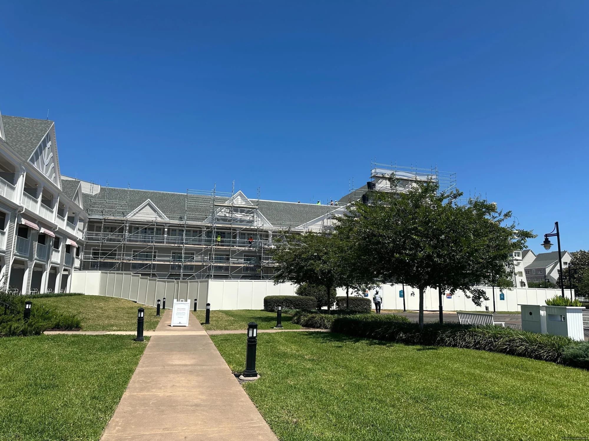 Exterior view of Disney's Yacht Club Resort showing completed south wing renovation work with construction scaffolding…