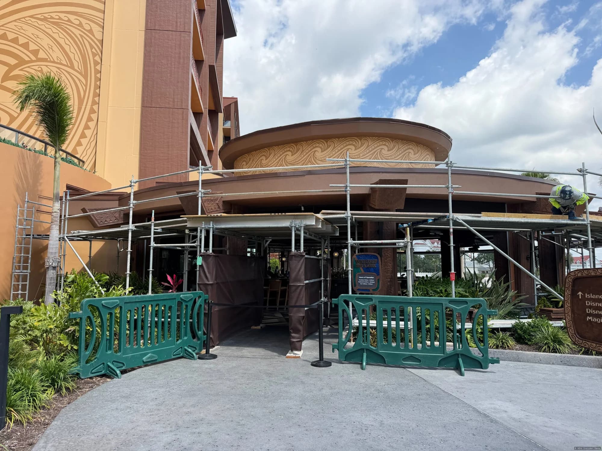 Outdoor bar area at Wailulu with Polynesian-style thatched roof during daytime, partially obscured by construction barriers