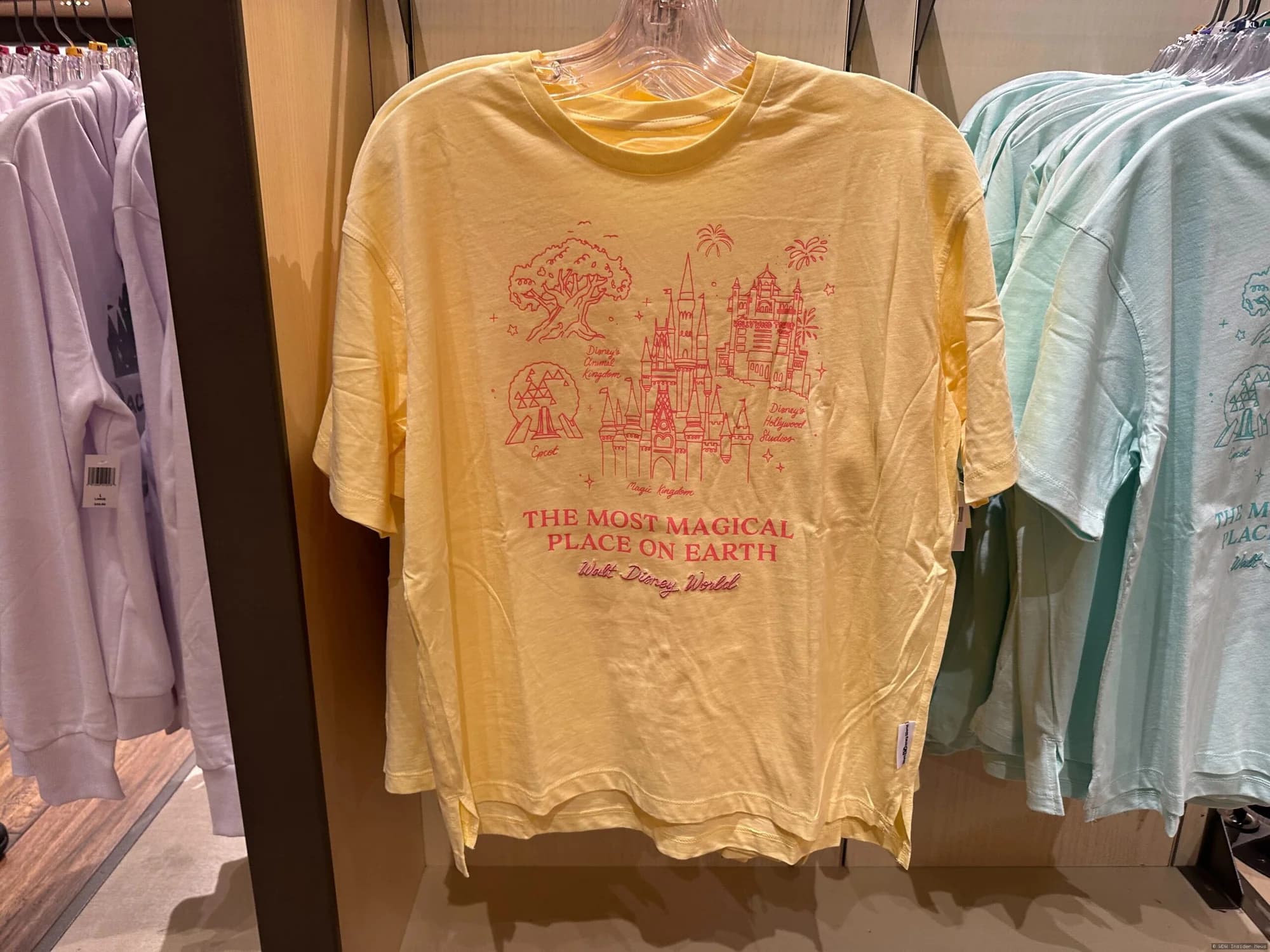 Four Walt Disney World theme park icons displayed on t-shirts in different colourways at World of Disney shop