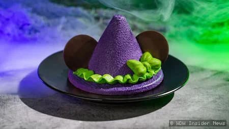 A spooky-themed dining area at Magic Kingdom with Halloween decorations and costumed Disney characters interacting with…