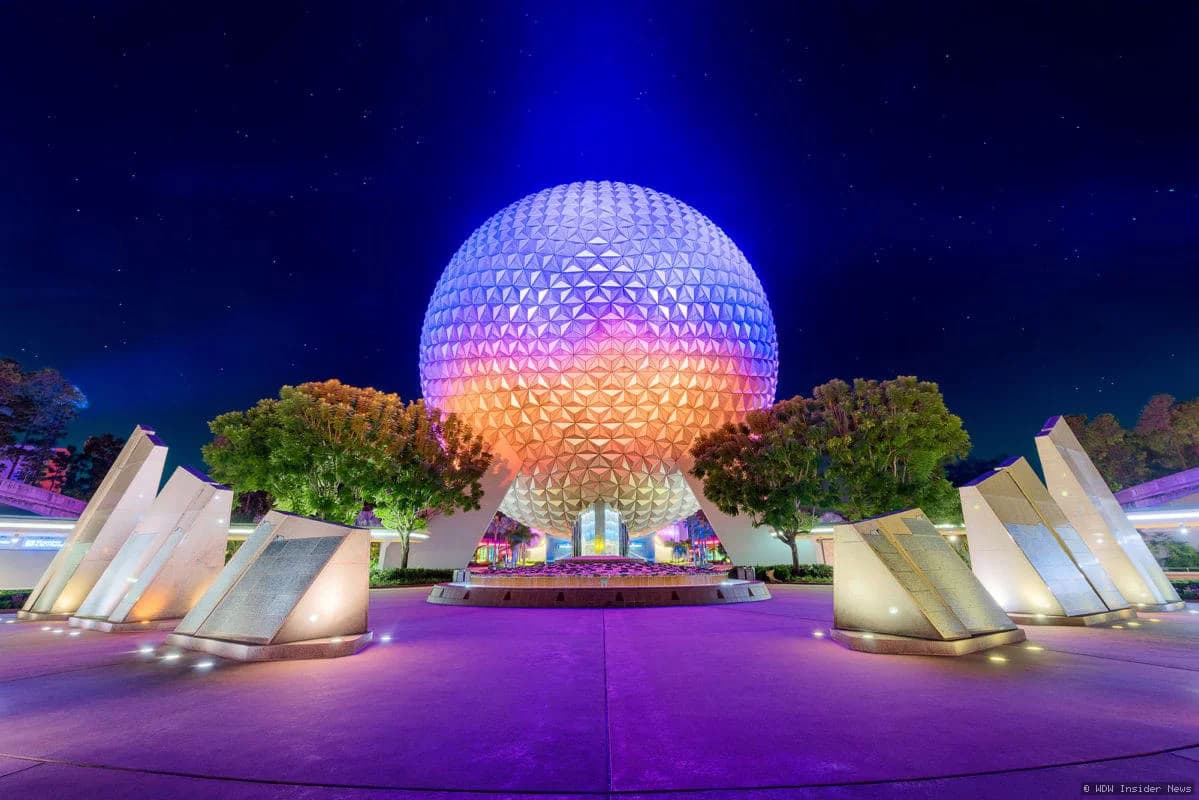 Florida resident holding a Disney summer ticket promotional offer displayed at Walt Disney World theme park entrance