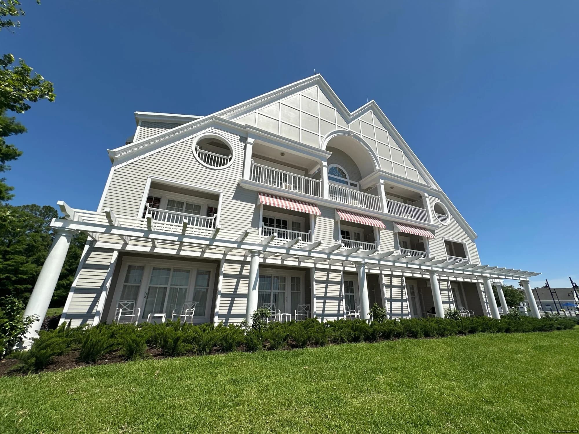 Exterior view of Disney's Yacht Club Resort showing completed south wing renovation work with construction scaffolding…