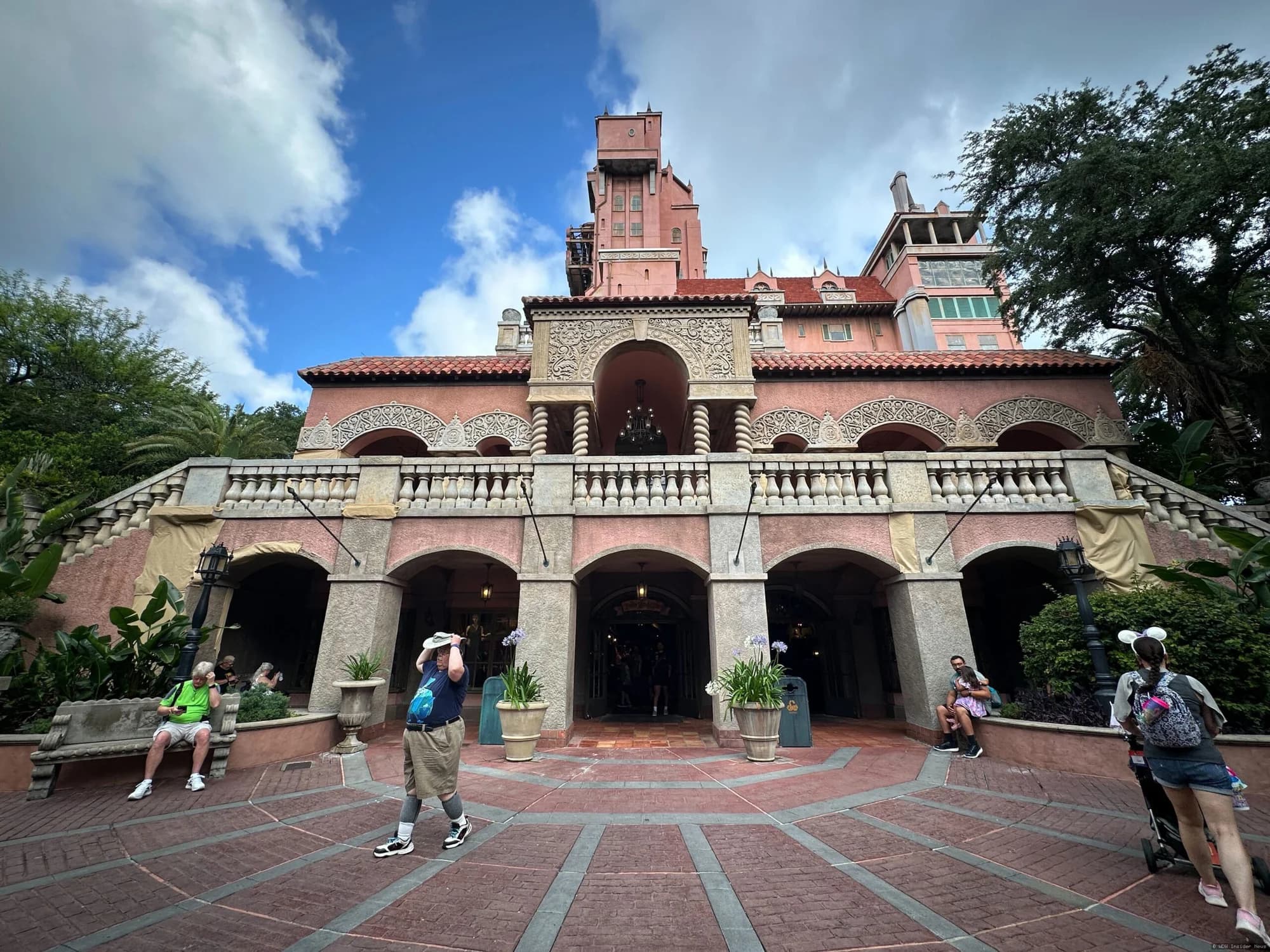 The Tower of Terror facade covered in construction scrim and scaffolding at Disney's Hollywood Studios theme park