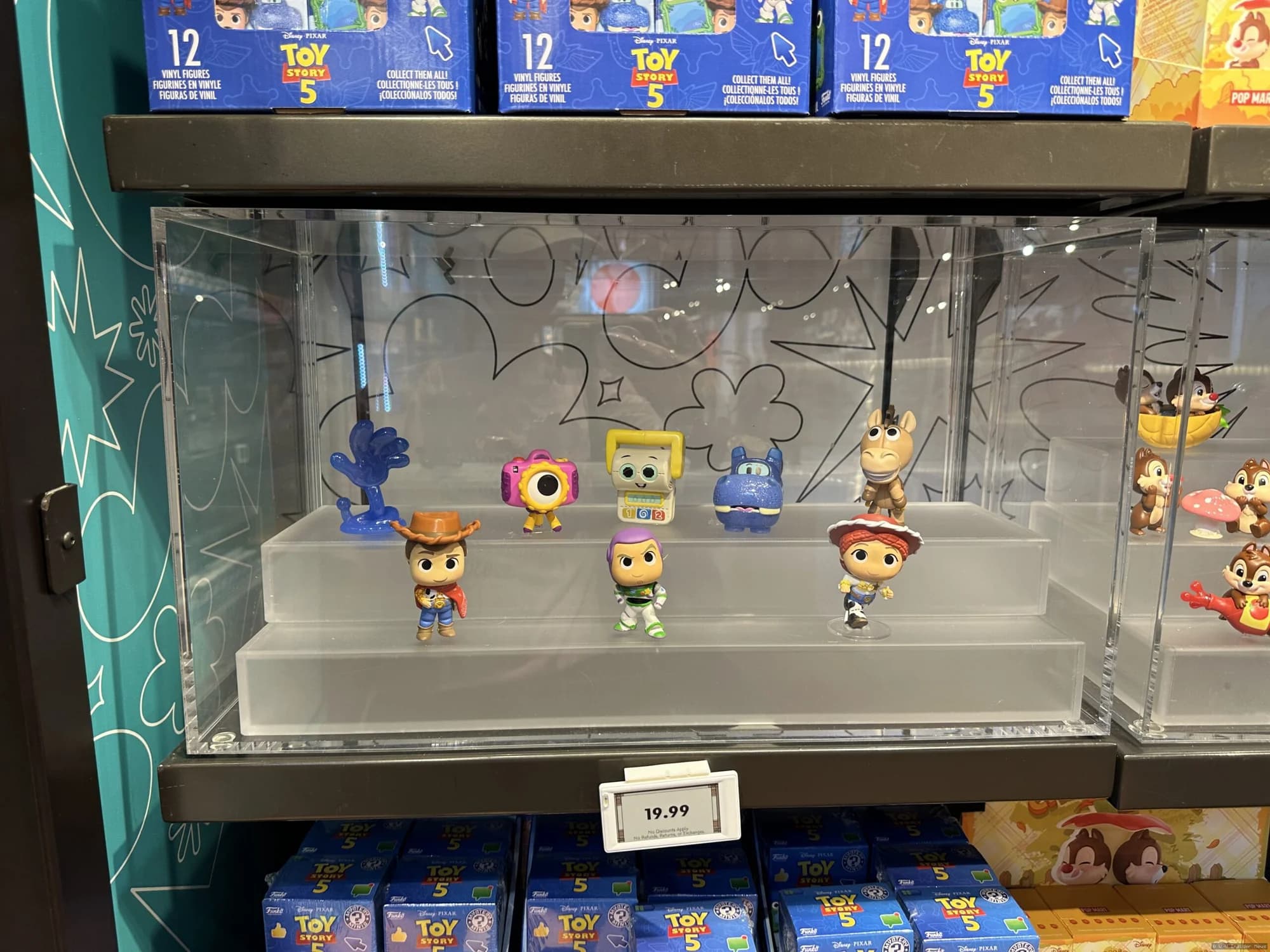 Mystery boxes displayed at Disney Springs featuring Stitch, Toy Story 5 and sweet treat themed collectible merchandise