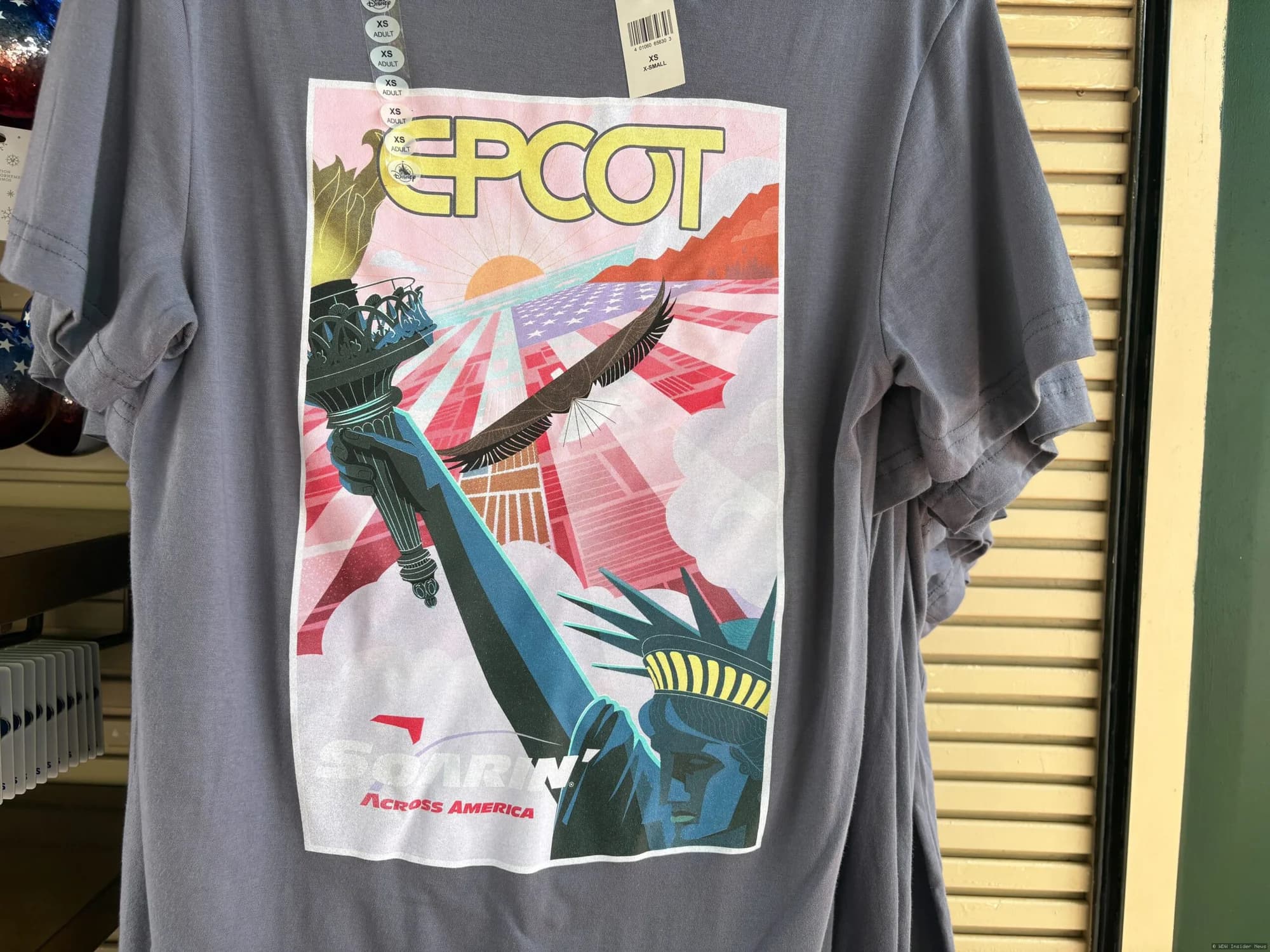 Soarin' Across America merchandise shirt displayed at EPCOT's Festival Market kiosk following the attraction's reopening