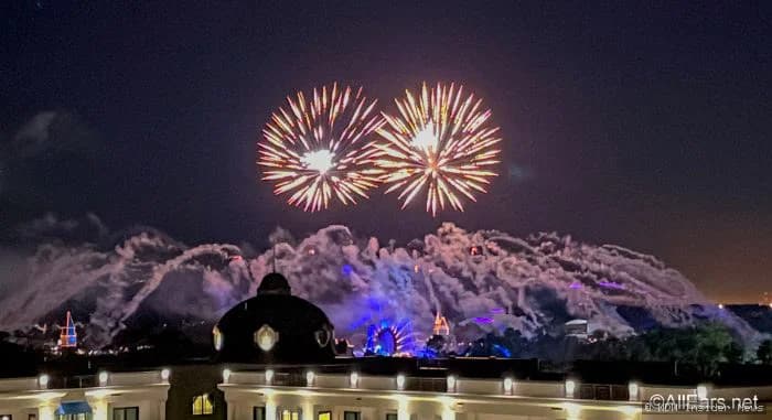 Elevated rooftop dining area at Disney World restaurant with tables, seating and evening atmosphere overlooking theme park
