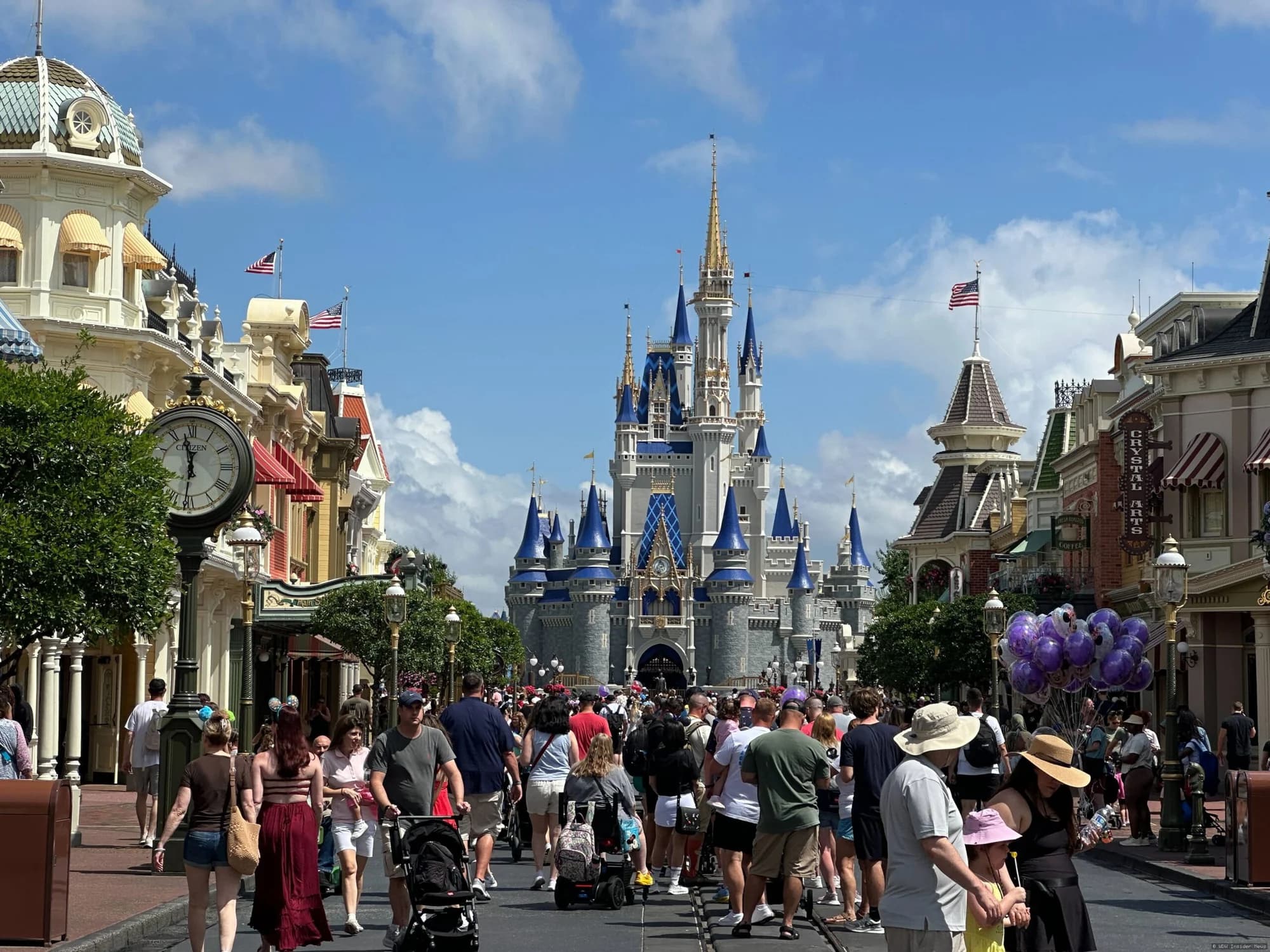 Cinderella Castle at Magic Kingdom with construction cranes being removed from around its base during repainting work