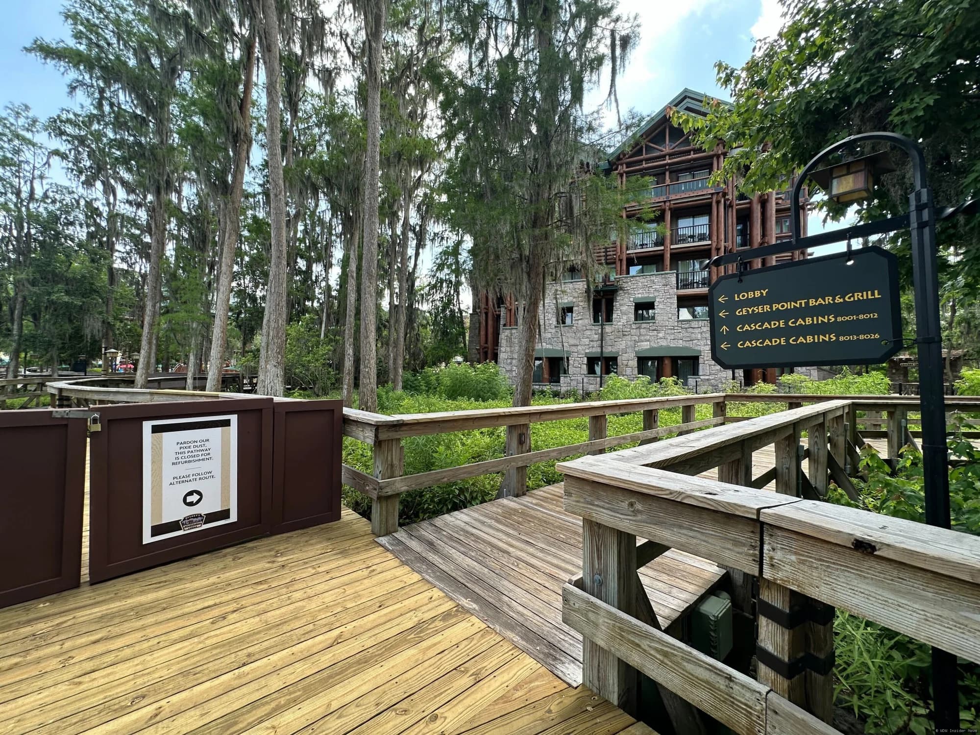Wooden boardwalk pathway at Disney's Wilderness Lodge resort, with construction barriers indicating closure for…