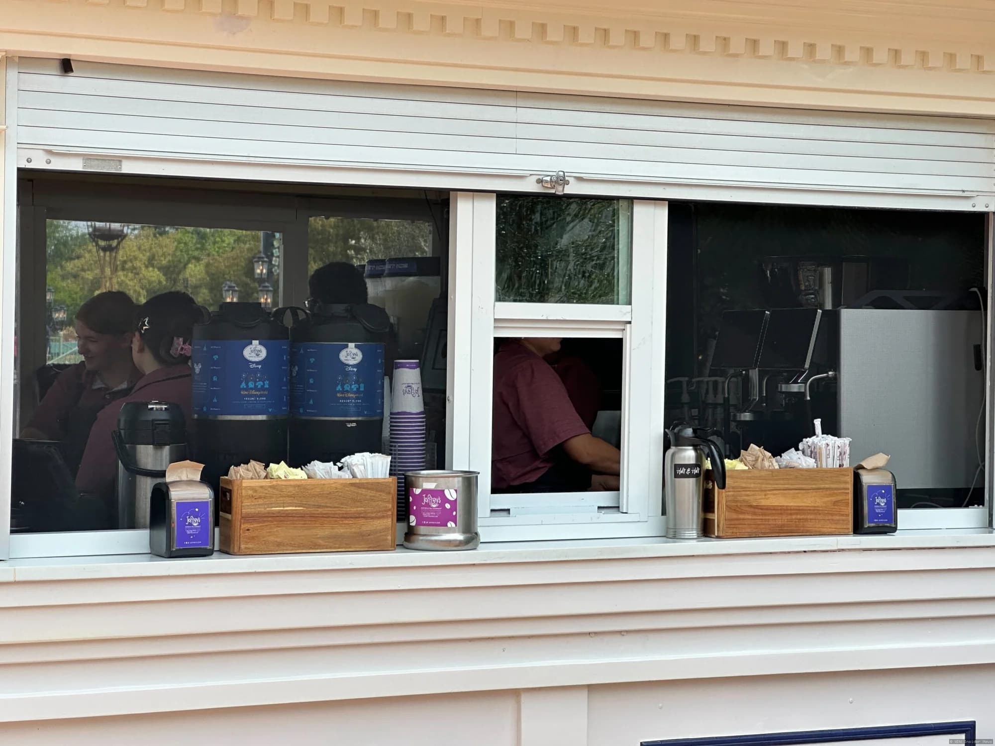 Protective mesh screens installed on the exterior of a Joffrey's coffee kiosk in EPCOT to prevent insects from entering