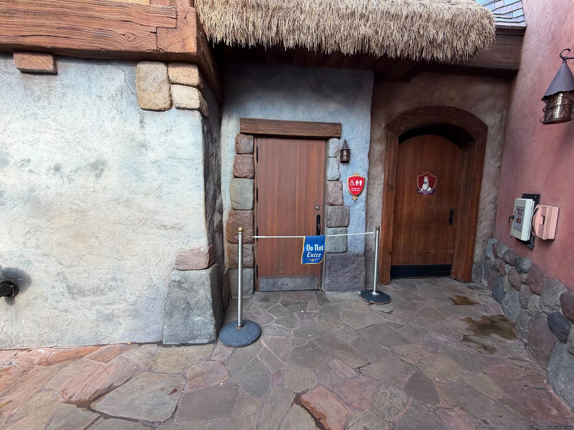 Tangled-themed restroom building at Magic Kingdom with closed signage during daytime refurbishment