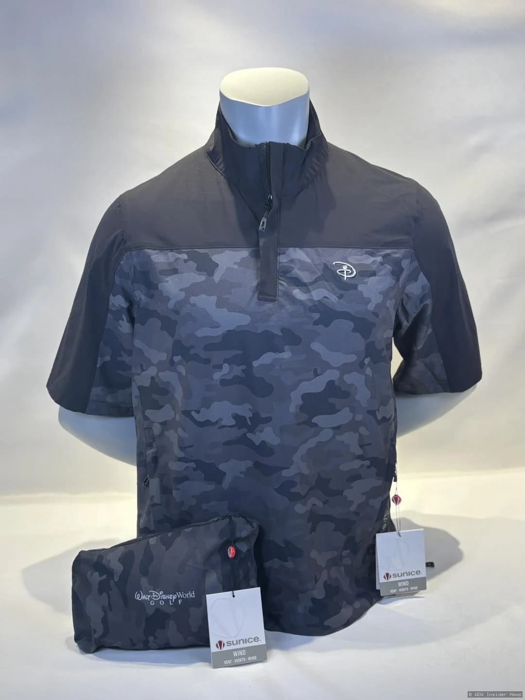 Character-themed putter covers and weather apparel displayed in a Walt Disney World Golf pro shop setting