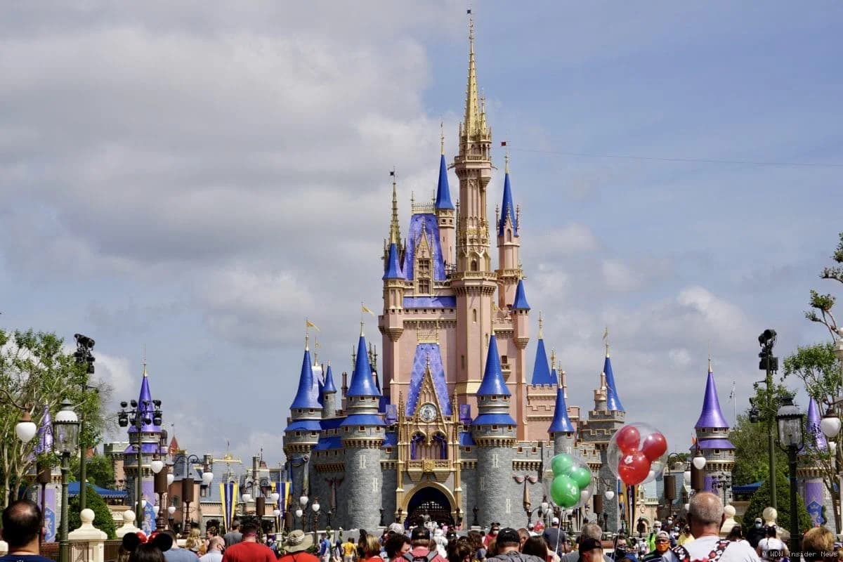 Cinderella Castle at Magic Kingdom with construction cranes being removed from around its base during repainting work