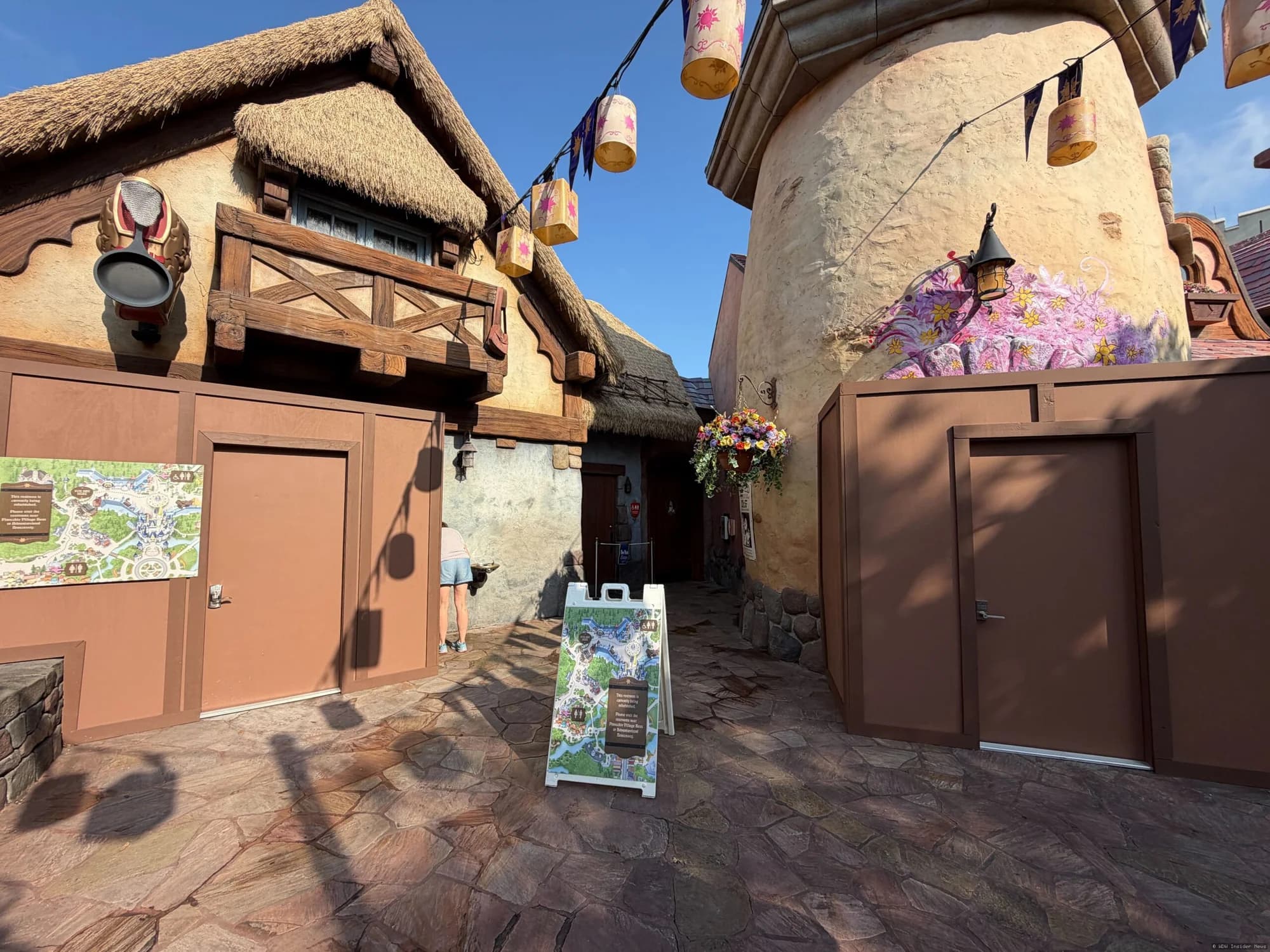 Tangled-themed restroom building at Magic Kingdom with closed signage during daytime refurbishment