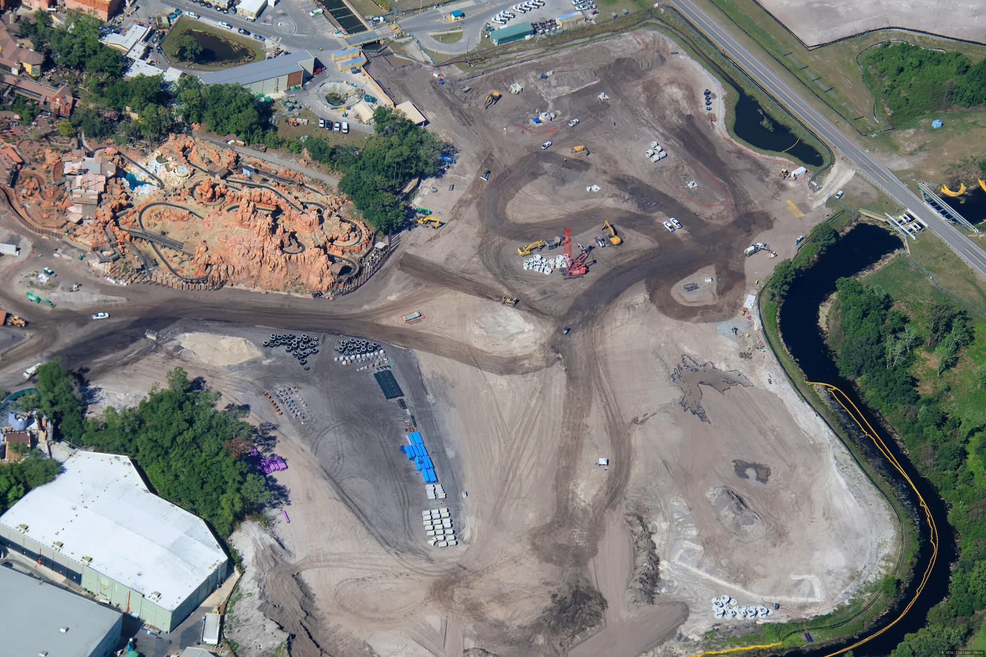 Aerial view of concrete retaining walls under construction along Liberty Square at Magic Kingdom